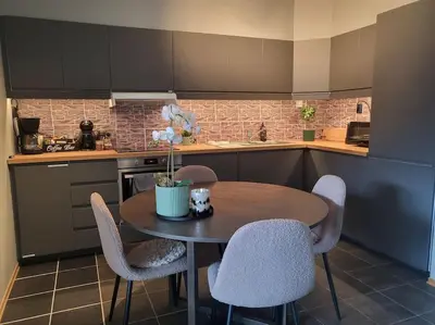a kitchen with a table and chairs in a kitchen at Ski in Ski out Trysil in the mountain of Norway 60m from the Slopes in Trysil