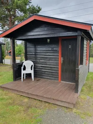 a white chair sitting on a wooden deck at Bjørgebu Camping AS in Mysusæter
