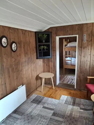 a room with wooden walls and a table and a window at Bjørgebu Camping AS in Mysusæter