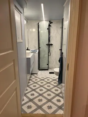 a bathroom with a shower and a sink and a toilet at New beautiful flat, parking! in Bergen