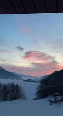 a painting of a sunset with a lake and mountains at New appartment in Lom inkl bedding in Lom