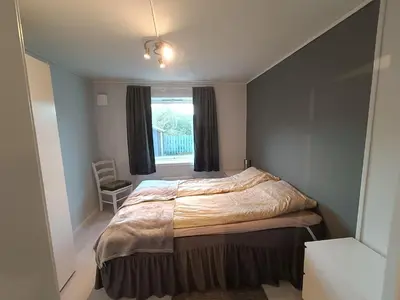 a bedroom with a large bed and a window at 3-roms leilighet, innsjekk uten vert. Egen inngang in Ålesund