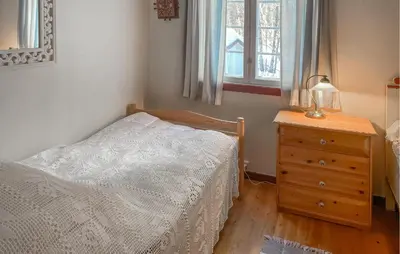 a bedroom with a bed and a dresser and a window at Gorgeous Home In Os I Østerdalen in Os