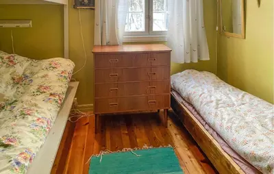 a bedroom with two beds and a dresser and a window at Gorgeous Home In Os I Østerdalen in Os