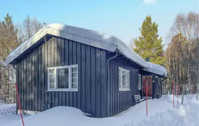 a small black building with snow on the roof at Gorgeous Home In Os I Østerdalen in Os