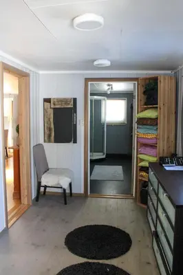 a room with a chair and a door to a bedroom at Hus nær lillehammer og sjusjøen in Lillehammer