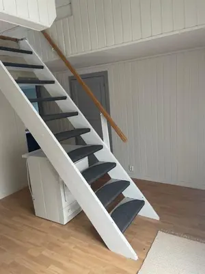 a spiral staircase in a room with a ceiling at Krokenes in Sylte