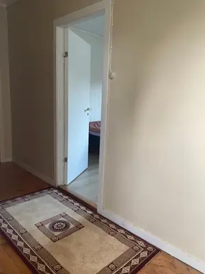 an empty room with an open door and a rug at Krokenes in Sylte