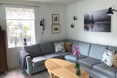 a living room with a couch and a table at Store Ringheim Apartment - Villa Solberg in Vossevangen