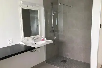 a bathroom with a sink and a shower at Store Ringheim Apartment - Villa Solberg in Vossevangen