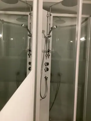 a shower with a glass door in a bathroom at Fjordview 35 in Lofthus