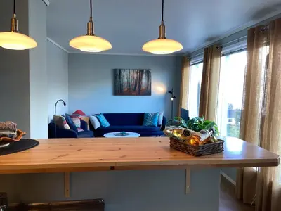 a living room with a table and a couch at Fjordview 35 in Lofthus