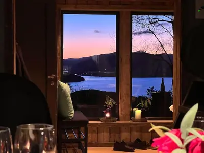 a view of a window with a view of a lake at Stabbur med fantastisk utsikt! in Steinkjer