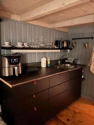 a kitchen with a sink and a counter top at Stabbur med fantastisk utsikt! in Steinkjer