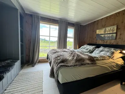 a bedroom with a large bed and a window at New and cozy family cabin on Golsfjellet in Golsfjellet