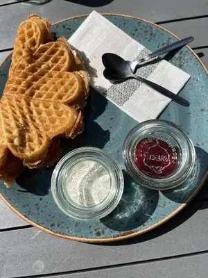 a plate with a waffle with a heart on it at New and cozy family cabin on Golsfjellet in Golsfjellet