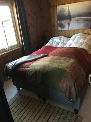 a bed sitting in a bedroom with a window at New and cozy family cabin on Golsfjellet in Golsfjellet