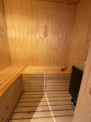 a wooden sauna with the sun shining on the wall at New and cozy family cabin on Golsfjellet in Golsfjellet