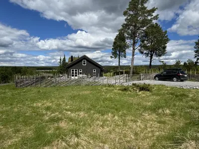 a car parked in front of a house at New and cozy family cabin on Golsfjellet in Golsfjellet