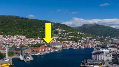 a view of a city with a yellow arrow at Bryggen // Fløyen Living in Bergen