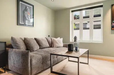 a living room with a couch and a table at Bryggen // Fløyen Living in Bergen