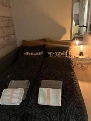 a bed with two pillows on it in a room at Byleilighet nær Fløyen in Bergen