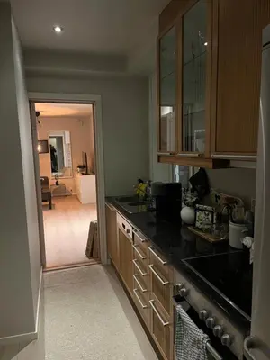 a kitchen with a counter top and a view of a room at Byleilighet nær Fløyen in Bergen