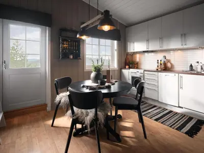 a kitchen with a table and chairs in a kitchen at Nesfjellet in Nes i Ådal