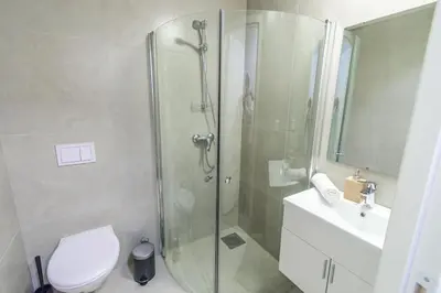 a bathroom with a shower and a toilet and a sink at 7 Soverom i hjertet av Bergen in Bergen