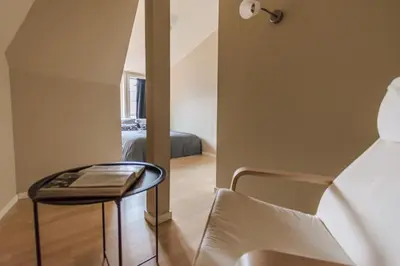 a room with a table and a chair and a bed at Supersentralt Bergen sentrum in Bergen