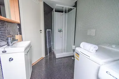 a bathroom with a toilet and a sink and a shower at Supersentralt Bergen sentrum in Bergen