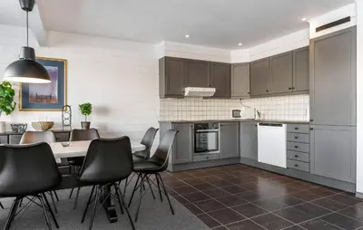 a kitchen with a table and black chairs in it at Pet Friendly Apartment In Hemsedal in Hemsedal