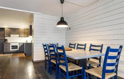 a dining room with a table and blue chairs at 3 Bedroom Nice Apartment In Hemsedal in Hemsedal
