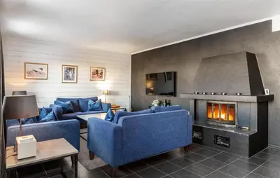 a living room with blue couches and a fireplace at Lovely Apartment In Hemsedal With Sauna in Hemsedal