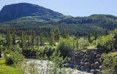 a creek in a field with a mountain in the background at Lovely Apartment In Hemsedal With Sauna in Hemsedal