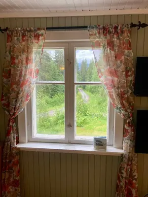 a window with curtains in a room at Friheten! in Notodden
