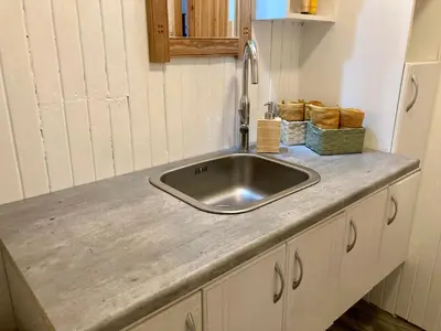 a kitchen counter with a sink in a kitchen at Friheten! in Notodden