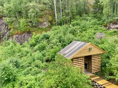 a small wooden cabin in the middle of a forest at Friheten! in Notodden