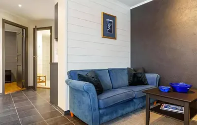 a blue couch in a living room with a table at 2 Bedroom Cozy Apartment In Hemsedal in Hemsedal