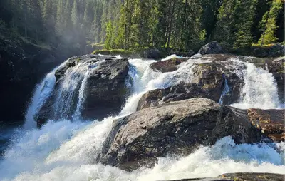 a waterfall on the side of a river with rocks at Pet Friendly Apartment In Hemsedal in Hemsedal
