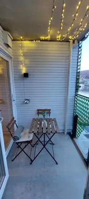 a patio with a picnic table and lights on it at Bergen city apartment in Bergen