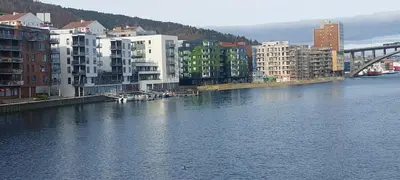a view of a river with buildings and a bridge at Bergen city apartment in Bergen