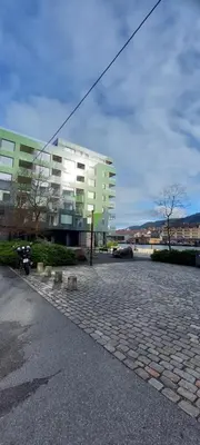 a large building in front of a brick road at Bergen city apartment in Bergen
