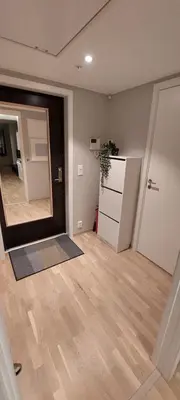 an empty living room with a mirror and a kitchen at Bergen city apartment in Bergen