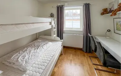 a bedroom with two bunk beds and a window at 3 Bedroom Cozy Apartment In Gålå in Frya