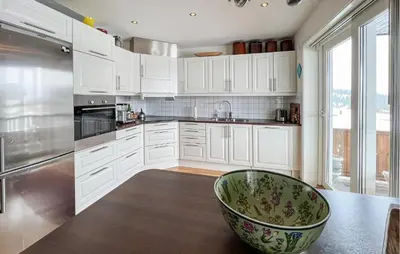 a kitchen with white cabinets and a large bowl on the counter at 3 Bedroom Cozy Apartment In Gålå in Frya