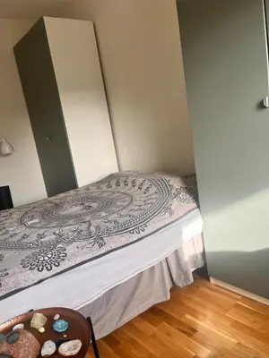 a bed in a room with a bedspread on it at Seagull Holiday& Businnes Apartment in Trondheim