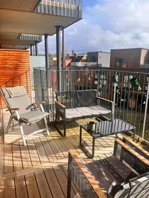 a patio with a bench and a table on a deck at Seagull Holiday& Businnes Apartment in Trondheim