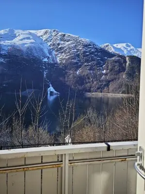 a view of a lake and snow covered mountains at Rekkehus Tyssedal Trolltunga in Tveit