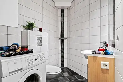 a bathroom with a washing machine and a sink at Modern Apartment In The Heart of Bergen in Bergen